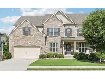 Charming two-story home with a brick facade, well-manicured lawn, attached garage, and inviting front porch at 2793 Bloom Cir, Dacula, GA 30019