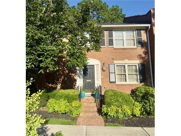 Charming brick townhome with black shutters and a beautifully landscaped front yard at 4620 Wieuca Ne Rd # 42, Atlanta, GA 30342