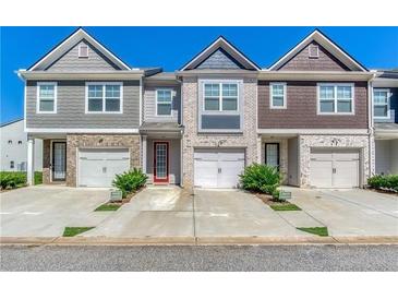 Charming townhomes featuring attached garages, private driveways, and stylish brick and siding exteriors at 5009 Longview Walk, Decatur, GA 30035