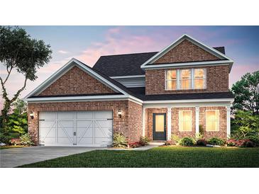 Charming two-story brick home with a manicured lawn, attached two car garage, and covered front porch at 1651 Tide Mill Rd, Cumming, GA 30040