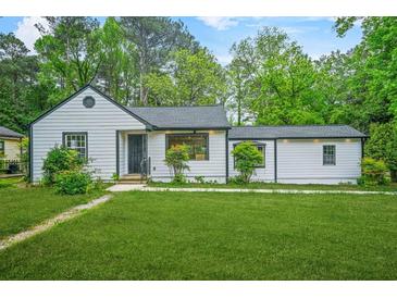 Charming bungalow with a freshly manicured lawn and meticulously maintained landscaping at 1712 Venetian Sw Dr, Atlanta, GA 30311