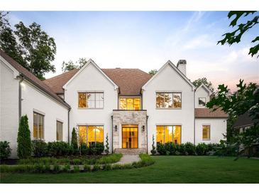 Stunning two-story home featuring a manicured front yard, stone accents, and a welcoming entrance at 490 Mount Paran Rd, Atlanta, GA 30327