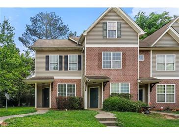 Traditional townhome with brick and vinyl siding, covered entrances, and well-maintained landscaping at 4670 Ernest Dr, Forest Park, GA 30297