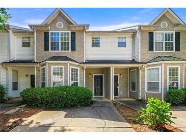 Charming townhome featuring a well-manicured front yard and inviting entrance at 2465 Brianna Dr, Hampton, GA 30228
