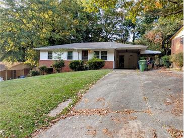 Charming single-story home with a covered carport and a well-maintained front yard at 3213 Jamaica Nw Rd, Atlanta, GA 30318