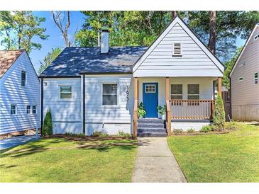 Charming home with a welcoming front porch, blue door, and well-manicured lawn at 1673 Richland Sw Rd, Atlanta, GA 30311