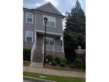 Two-story home with a brick foundation, steps to the front porch, and gray siding at 3242 Cascade Parc Sw Blvd, Atlanta, GA 30311