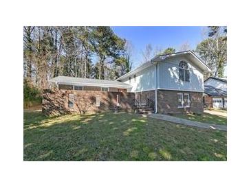 Charming two-story home with a brick facade and well-maintained front lawn at 1038 Seven Springs Cir, Marietta, GA 30068