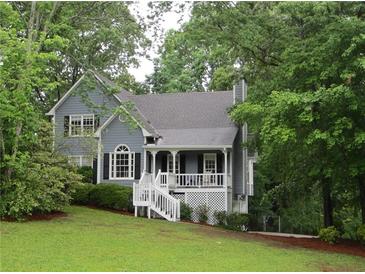 Charming two-story home with a landscaped yard and inviting front porch, surrounded by mature trees at 27 Edgar Ct, Hiram, GA 30141