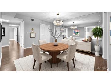 Bright dining area featuring modern chandelier, wood table, and white buffet at 6851 Ne Roswell Rd # C4, Atlanta, GA 30328