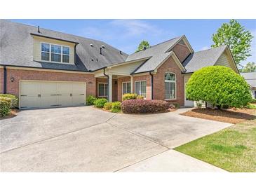 Charming brick home featuring a two-car garage, well-maintained landscaping, and a spacious driveway at 2703 Brookhavenrun Cir, Duluth, GA 30097