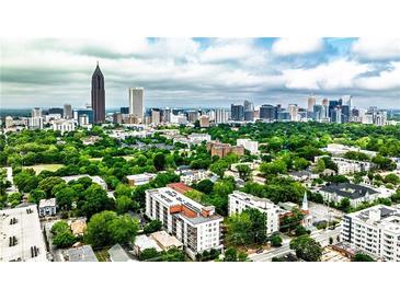 Stunning aerial view of Atlanta's skyline with lush green trees and scattered buildings beneath a partly cloudy sky at 525 Parkway Dr # 218, Atlanta, GA 30354