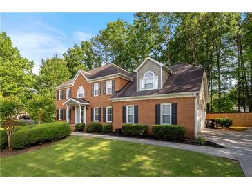 Charming two-story brick home with lush landscaping and a well-manicured lawn in a desirable neighborhood at 5661 Fairwood Nw Dr, Acworth, GA 30101