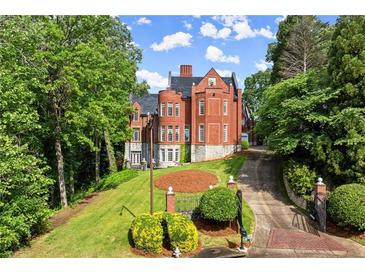 An impressive two-story home boasting an impeccable yard and beautiful brickwork throughout the exterior elevation at 3863 Streamside Se Dr, Marietta, GA 30067