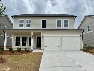Charming two-story home with a two-car garage and well-manicured front lawn at 2101 Boxwood Circle Se, Conyers, GA 30094