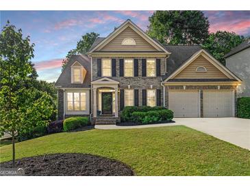 Charming two-story home with a well-manicured lawn and two-car garage offers classic suburban appeal at 4876 Sara Creek Way, Sugar Hill, GA 30518