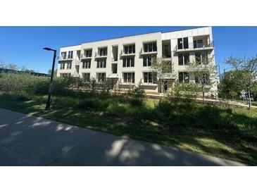 Modern three-story apartment building featuring balconies and lots of natural light in a landscaped setting at 127 Stein Steel Street # 112, Atlanta, GA 30316