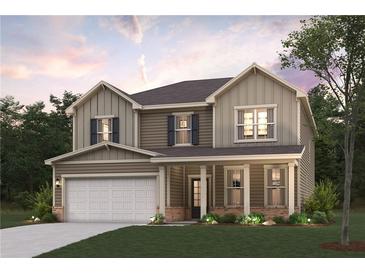 Charming two-story home with covered front porch, attached garage, and beautifully landscaped front yard at 4028 Trimrose Ct, Atlanta, GA 30349