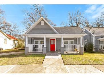Charming gray home with a welcoming front porch and bright red front door at 1091 Longley Nw Ave, Atlanta, GA 30318