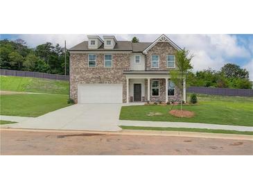 Charming two-story brick home featuring a well-manicured lawn and a two-car garage at 1109 Georgian Point Dr, Lawrenceville, GA 30045