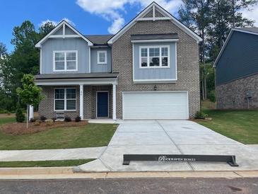 Charming two-story home with brick and siding, a two-car garage, and a well-manicured front yard at 376 Collier Mills Rd Dr, Lawrenceville, GA 30045