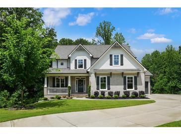 Charming two-story home with beautiful landscaping, symmetrical windows, and a welcoming front porch at 4383 Capstone Ne Ct, Roswell, GA 30075