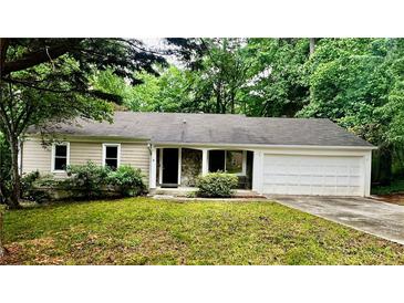 Inviting one-story home with a two-car garage, stone accents, and a well-manicured front yard at 2705 Rhoanoke Dr, Duluth, GA 30096