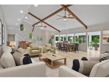Bright open-concept living room with vaulted ceilings, exposed beams, and natural light at 605 Ga 120 Hwy, Roswell, GA 30075