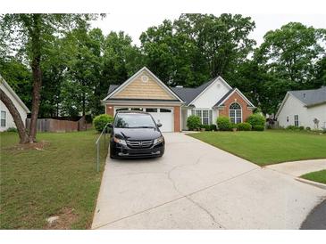 Charming single-story home with a well-manicured lawn and a paved driveway at 2840 General Lee Way, Buford, GA 30519