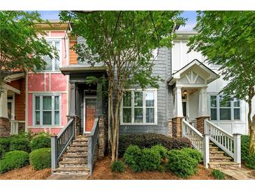 Charming townhomes with stone accents, landscaped front yards, and inviting staircases leading to covered entryways at 3642 Princeton Ave, Atlanta, GA 30337