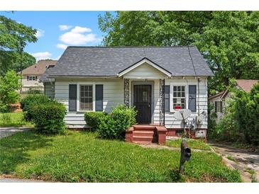 Charming home featuring gray shutters, landscaped bushes, and a cozy front porch at 1377 Pine Ave, Atlanta, GA 30344