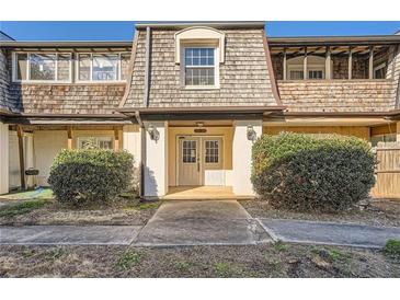 Charming townhome with a welcoming front entrance and well-maintained landscaping at 123 Rue Fontaine, Lithonia, GA 30038