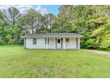 Charming single-story home with a well-manicured lawn and mature trees at 4384 Raven Valley Ct, Decatur, GA 30035