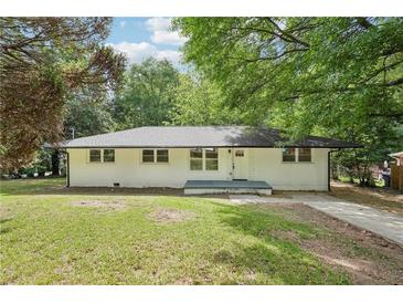 Charming painted brick home with a well-maintained lawn and mature trees at 5729 Jefferson Ave, Forest Park, GA 30297