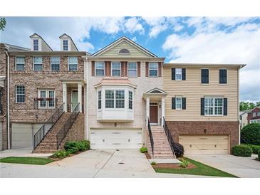 Charming townhome showcasing brick facade, well-maintained landscaping, and convenient garage access at 4306 Laurel Creek Se Ct, Smyrna, GA 30080