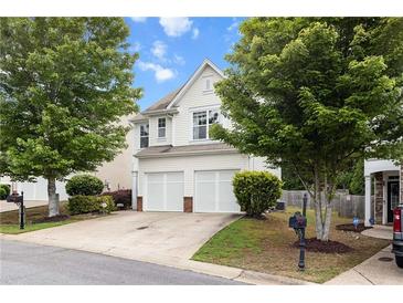 Charming two-story home with a two-car garage, well-manicured lawn, and mature trees at 720 Mountain Laurel Dr, Canton, GA 30114