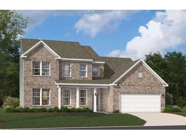 Charming brick two-story home with a manicured lawn and attached two-car garage and covered porch at 509 Altamaha Ct, Locust Grove, GA 30248