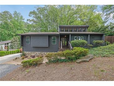 Contemporary home with modern design elements and mature landscaping at 3165 Brookview Dr, Marietta, GA 30068