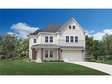 Charming two-story home featuring a mix of brick and vertical siding, complemented by a well-manicured lawn at 4850 Summerchase Ln, Cumming, GA 30028