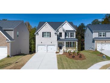 Charming two-story home featuring a two-car garage and a welcoming front porch at 1871 Lacebark Elm Way Way, Lawrenceville, GA 30045