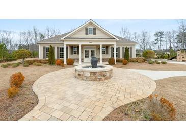 Charming single-story home with a welcoming front yard and beautiful water feature at 7575 Old Camp Lndg, Cumming, GA 30040