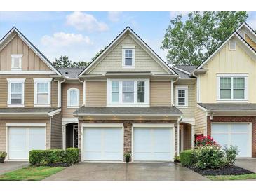 Charming townhome with stone accents, two-car garage, and well-maintained landscaping at 2012 Ellison Nw Way # 15, Kennesaw, GA 30152