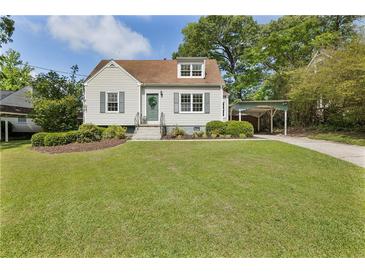 Charming single-Gathering home featuring classic architecture, well-manicured lawn, and a convenient covered carport at 1972 Wingate Rd, Chamblee, GA 30341