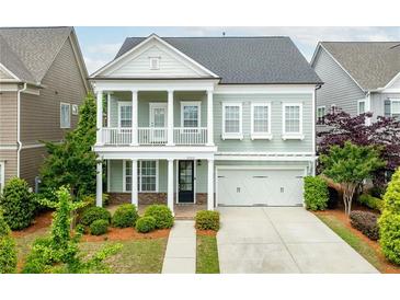 Charming two-story home with a welcoming front porch and well-manicured landscaping at 2222 Haventree Ct, Lawrenceville, GA 30043