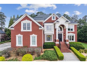 Beautiful red brick two-story home with manicured landscaping and a grand entrance at 3364 Kylee Dawn Cir, Lawrenceville, GA 30045