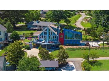 Stunning multi-level home with unique architecture and waterfront views, perfect for luxury living at 4940 Sunrise Ln, Cumming, GA 30041