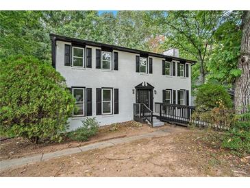 Charming two-story home with brick facade, black trim, and landscaped front yard at 3333 Devaughn Ne Dr, Marietta, GA 30066