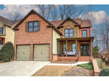 Charming brick two-story home with a two-car garage and covered front porch at 233 Yorkshire Ln, Villa Rica, GA 30180