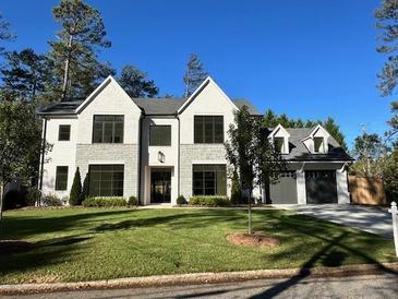 Beautiful new construction home with a 3-car garage and an expansive front yard at 4550 Jolyn Pl, Sandy Springs, GA 30342