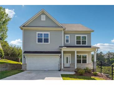 Charming two-story home with attached garage and well-manicured lawn in a desirable neighborhood at 2646 Neighborhood S Walk, Villa Rica, GA 30180